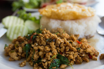 close up spicy stir-fried chicken curry and egg on dish.