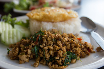 close up spicy stir-fried chicken curry and egg on dish.