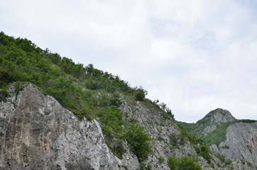 Cliffs with rare overgrowth under cloudy sky