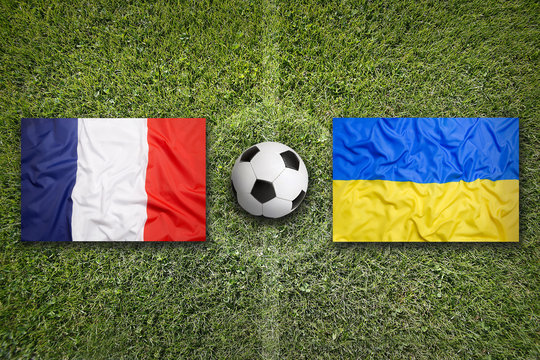 France vs. Ukraine flags on soccer field