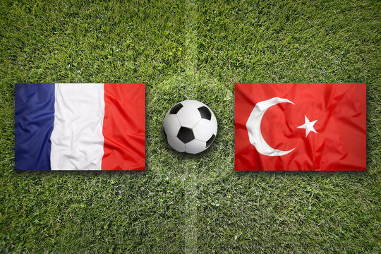 France vs. Turkey flags on soccer field