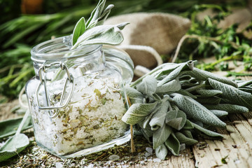 Sea salt, milled with sage in a glass jar, fresh herbs, vintage