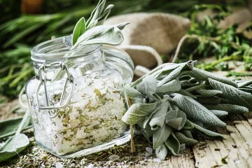 Photo sur Plexiglas Aromatique Sea salt, milled with sage in a glass jar, fresh herbs, vintage