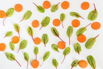 Beet leaves and carrot on white background. Top view, Flat lay.