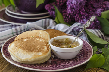Pancakes for breakfast with plum jam and lilac   
