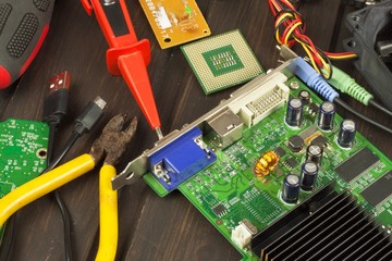 Table electronics repairman. Home computer repair. Desktop clutter electronics repairman. Recycling of multiple computers. Sales of electronic parts.
