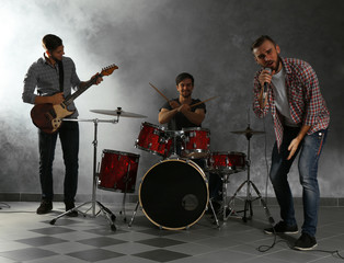 Obraz premium Musicians playing musical instruments and singing songs in a studio