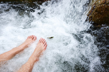rest relaxing foot in waterfall in tropical forest