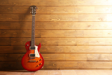 Electric guitar on wooden background - Powered by Adobe