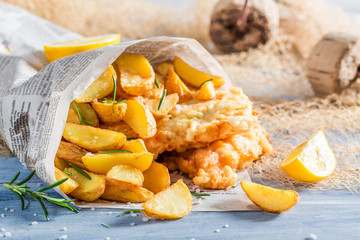 Closeup of delicious fish cod with chips with lemon - obrazy, fototapety, plakaty