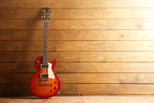 Electric guitar on wooden background