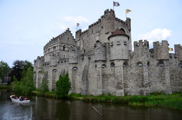 Fototapeta na wymiar Tourists enjoying the view on the castle Gravensteen in the picturesque city of Gent in Belgium.