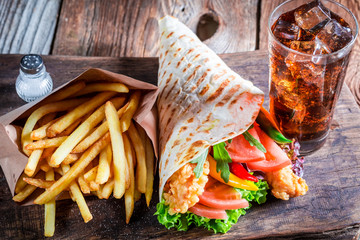 Closeup of tasty kebab with fries and cod drink