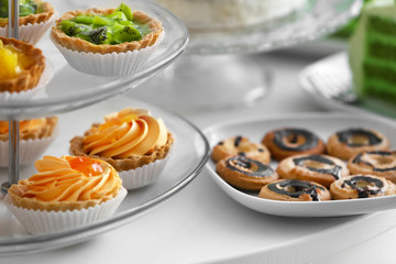 Different delicious desserts on table