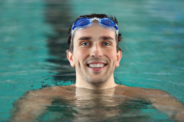 Head of handsome man in the swimming pool