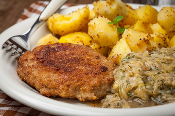 Delicious meal of minced meat cutlet, potatoes and fried cabbage