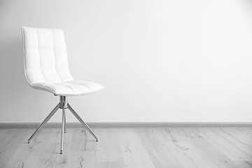 Cozy chair on wall background