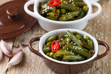 Spicy green beans and peas with spices in portion pots. Oriental cuisine