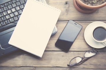 notepad on notebook and phone