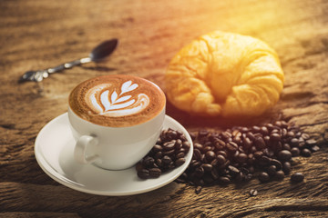 white coffee cup and roasted coffee beans around