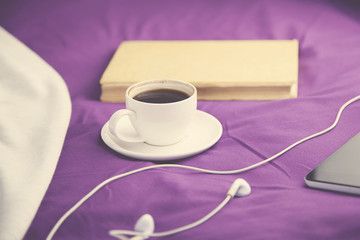 coffee and phone on bed