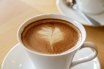 white coffee cup on wooden table