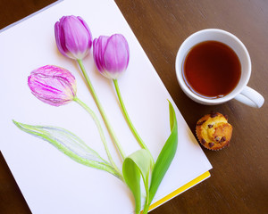 Mixed art. Composition of sketch of violet tulip and two fresh tulips forming beutiful bouquet. Tea in white cup and mini cake. Wooden brown background. Creativity consept. Relax. Be creative