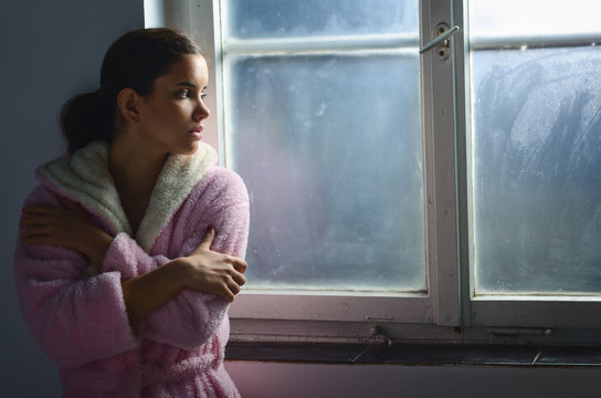 Beautiful ill sad cancer patient girl pajamas hospital window  