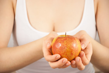 A young beautiful woman with an apple