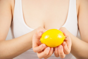 A young beautiful woman with a lemon