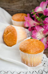 Freshly baked cupcakes on wooden background. Selective focus