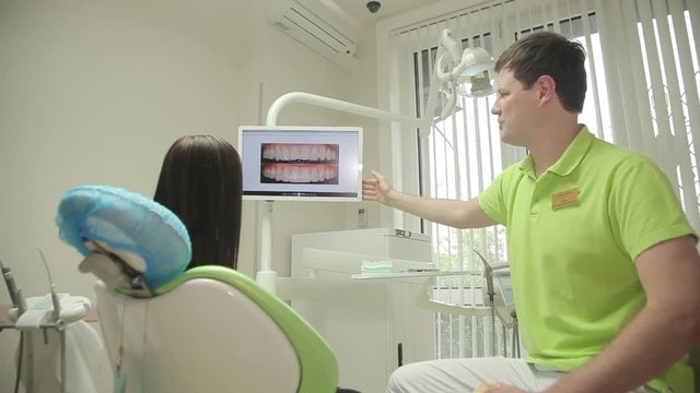 dentist talking to a patient in medical office