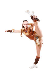 Young professional cheerleader dressed in a warrior costume  standing on one leg . Vertical splits