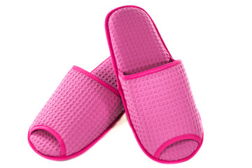A pair of pink slippers on a white background.