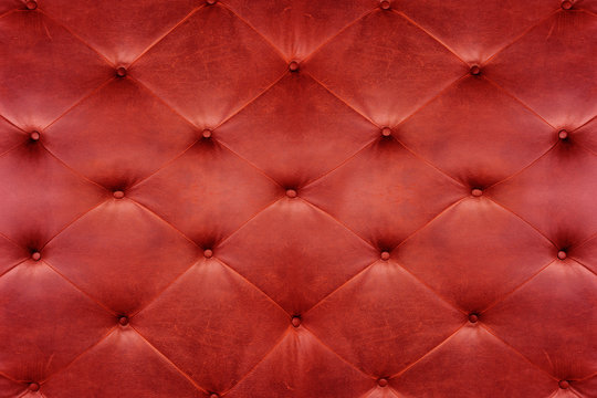 Genuine red leather upholstery background for a luxury decoratio