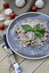 A vegetarian pasta with mushrooms and cherry tomatoes, parmesan