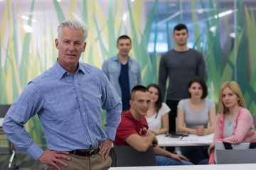 portrait of  teacher with students group in background