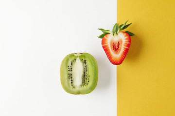 Kiwi and strawberry on yellow white background fruits summer