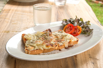 Pizza Toast,Glass of water on wooden table.