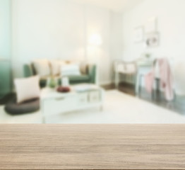 wooden table top with blur of living room in modern interior style