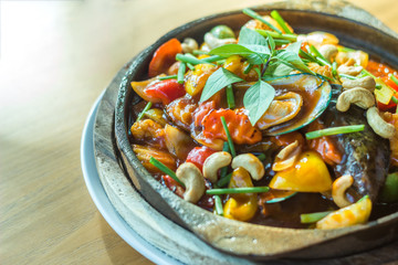 Sweet and sour sauce fried sea food with cashew nut in hot plate