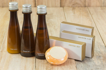 Tubes of bathroom amenity contains on wooden background