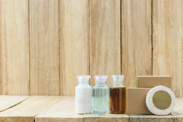 Tubes of bathroom amenity contains on wooden background