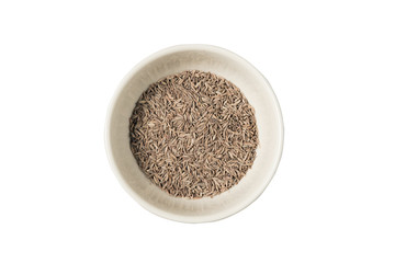 Isolated bowl of dried cumin seed on the white background
