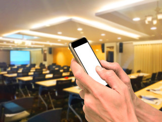 Hands using smartphone in meeting room