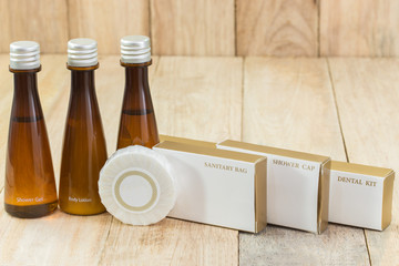 Tubes of bathroom amenity contains on wooden background