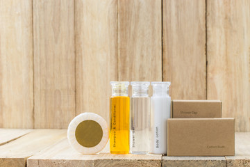 Tubes of bathroom amenity contains on wooden background