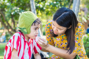 Little boy Bleeding at the mouth and mother help first aid to hi
