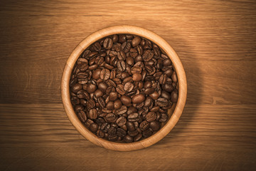 Coffee beans in a wooden bowl