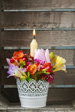Beautiful table decoration with colorful flowers and candle